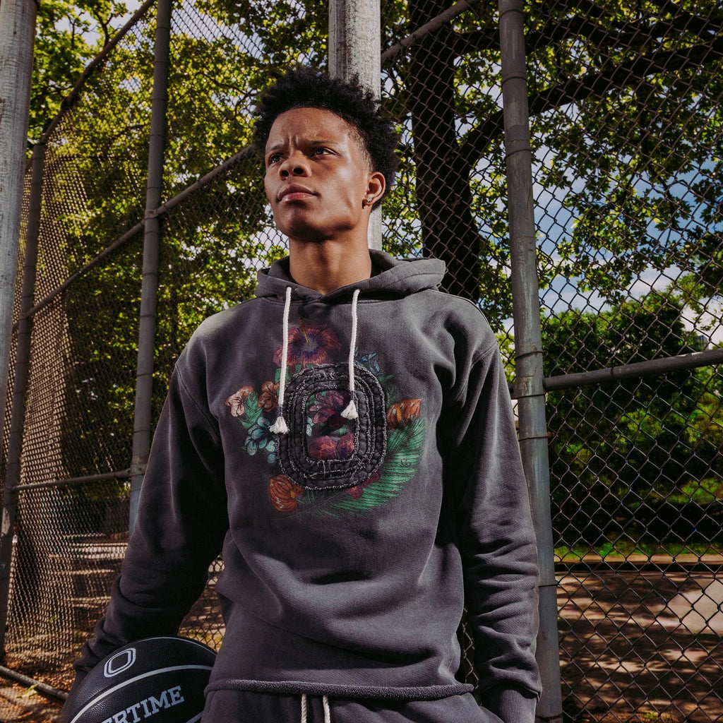 Basketball player Anderson "Shift" Diaz wearing the Overtime Hooping is Paradise hoodie