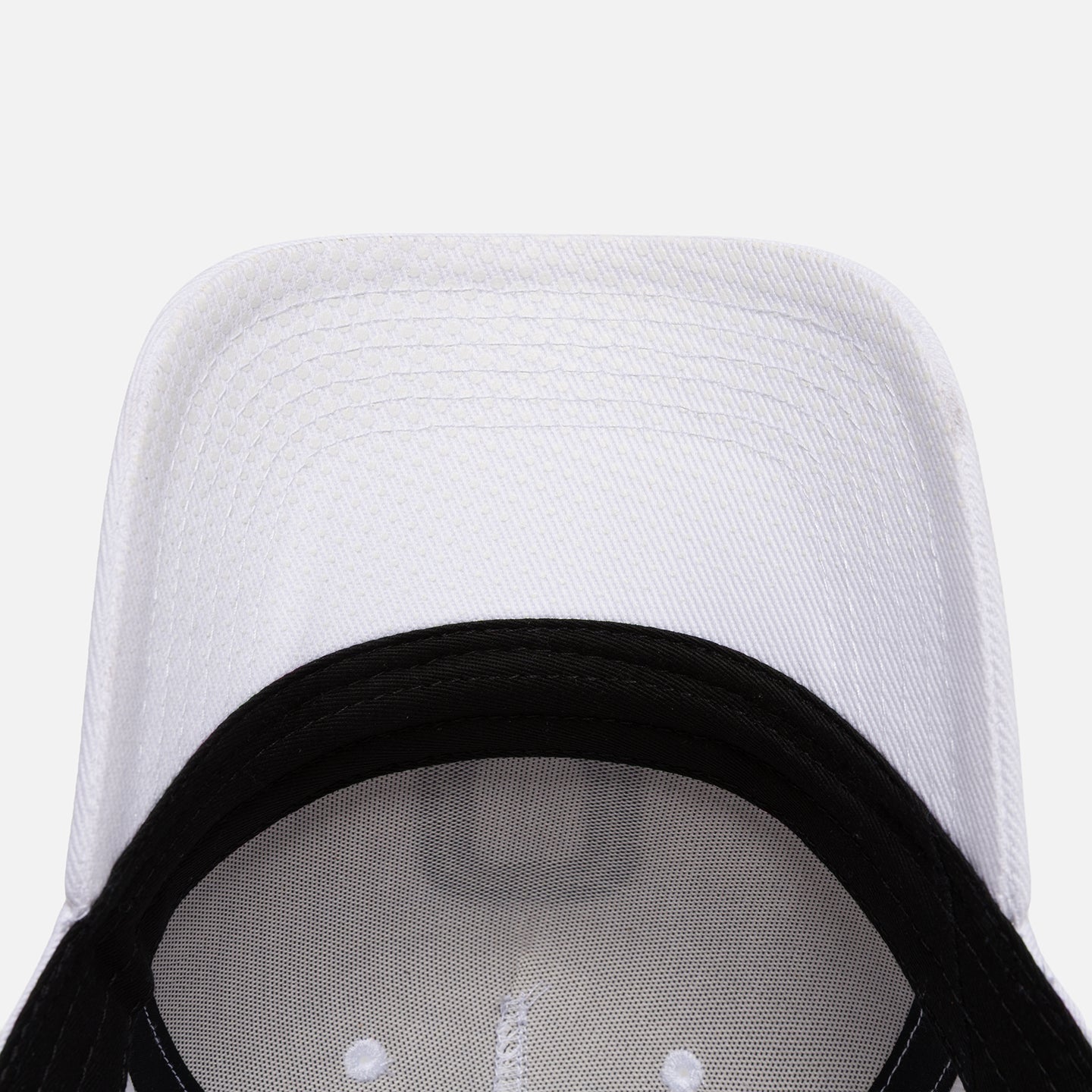 Close-up of a white baseball cap with white brim
