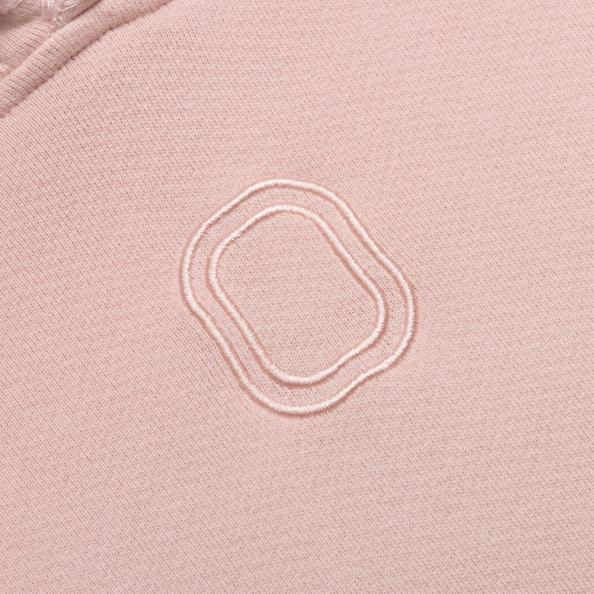 Close-up of embroidered "O" logo