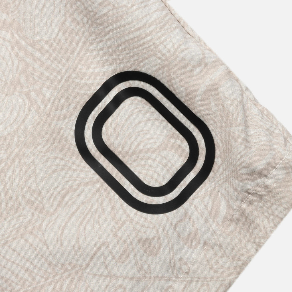 Close-up of a decorative pillow with a black and white pattern on a beige background