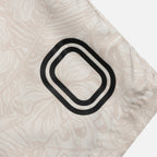 Close-up of a decorative pillow with a black and white pattern on a beige background