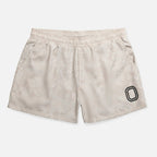 Beige shorts with a black "O"
logo 