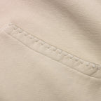 Close-up of beige fabric with a visible seam