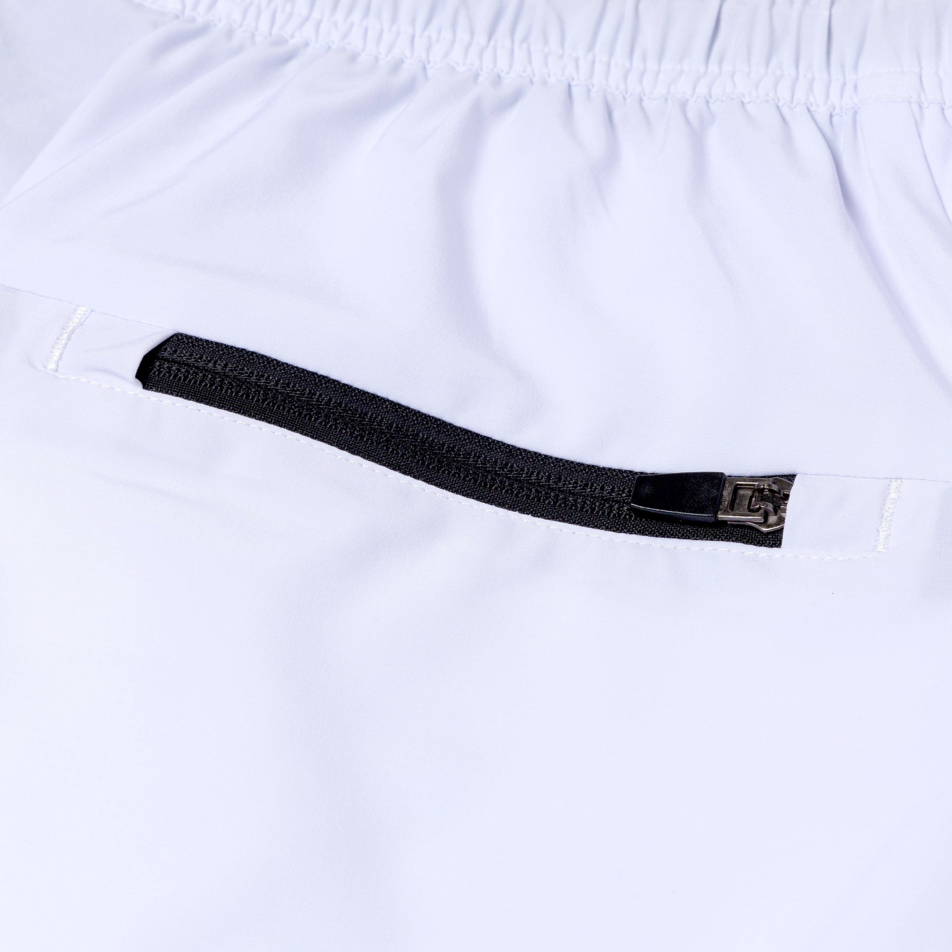 Close-up of a white shorts with a black zipper