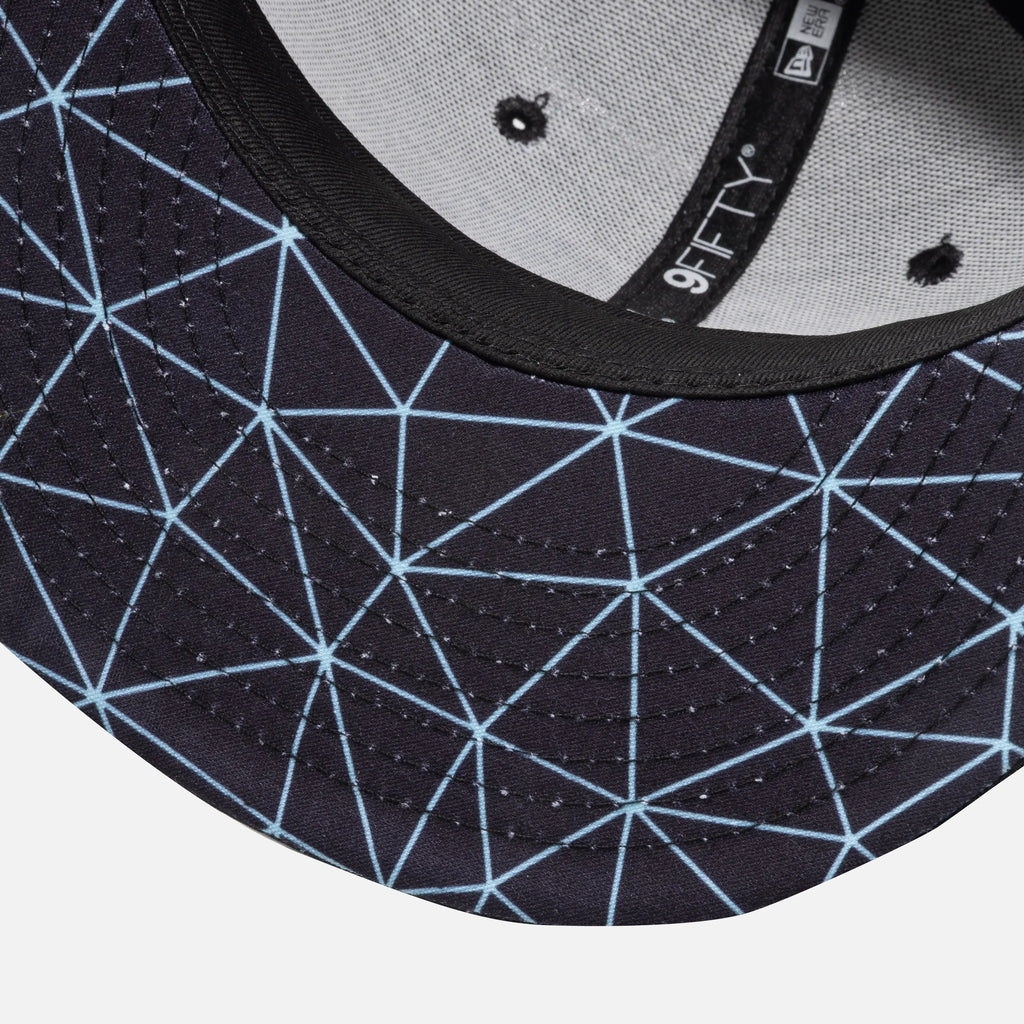 Close-up of a cap with geometric pattern on the brim