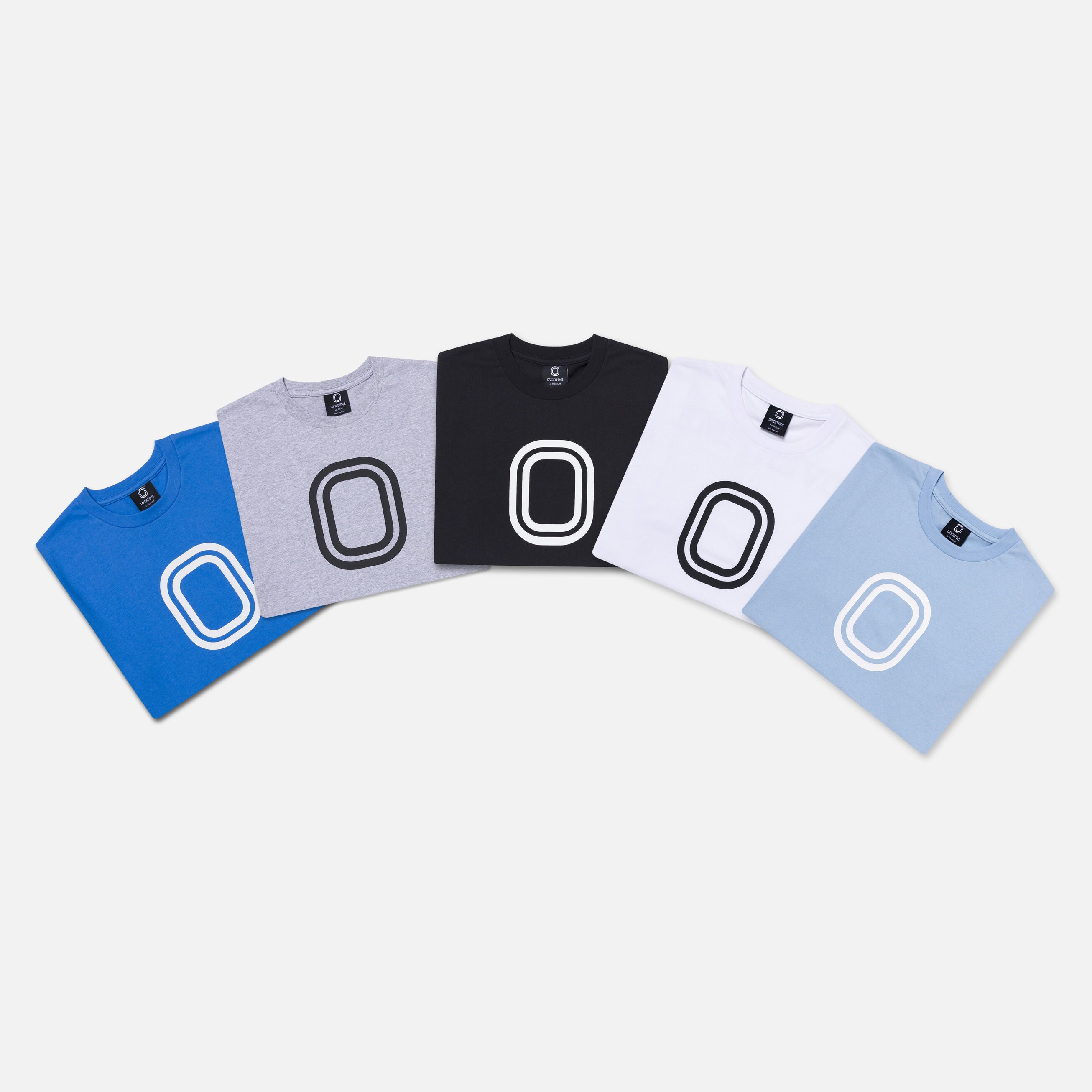 Five folded t-shirts in blue, gray, black, white, and light blue with "O" logos