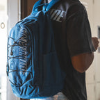 Kid wearing blue Overtime Fast Break backpack