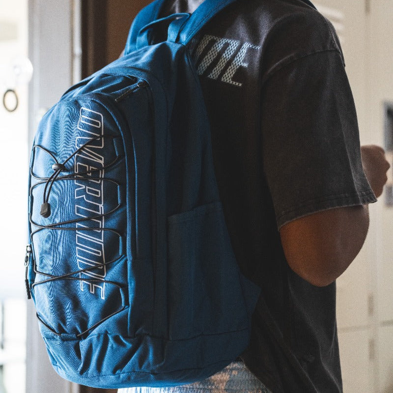 Kid wearing blue Overtime Fast Break backpack