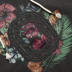 Close-up of a distressed "O" logo on a floral print