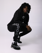 Ian Jackson wearing a black hoodie with a 'O' logo print on the chest and 'OVERTIME' print on the sleeve.