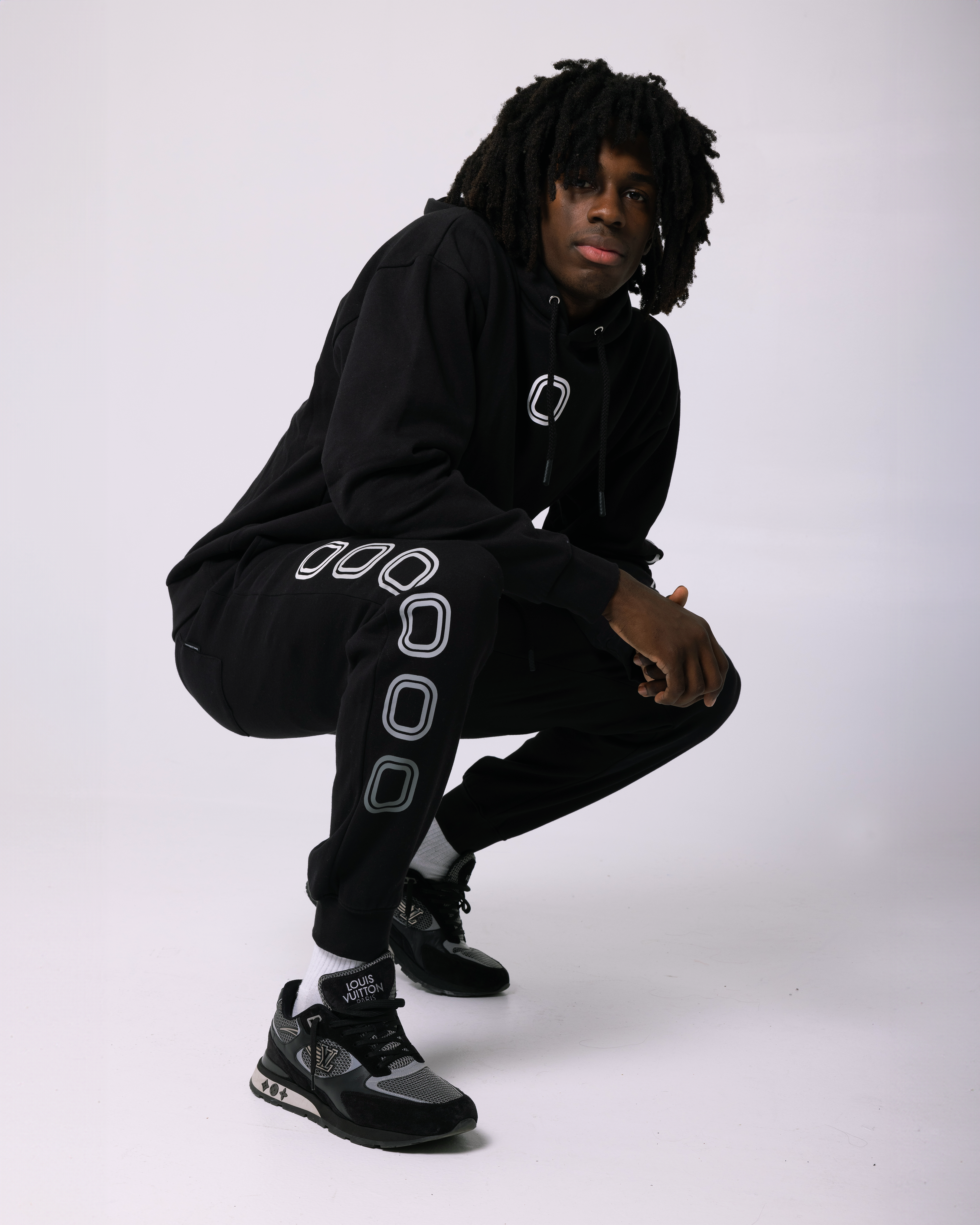 Ian Jackson wearing a black hoodie with a 'O' logo print on the chest and 'OVERTIME' print on the sleeve.