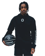 Rob Dillingham wearing a black hoodie with a 'O' logo print on the chest and 'OVERTIME' print on the sleeve.