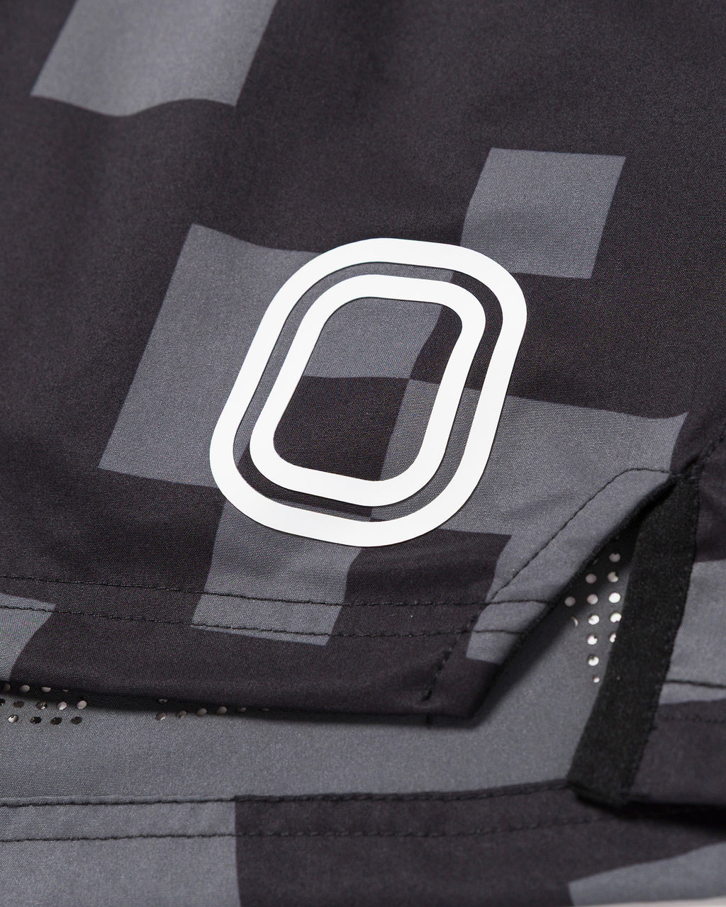 Close-up of a black and gray patterned shorts with white "O" Logo