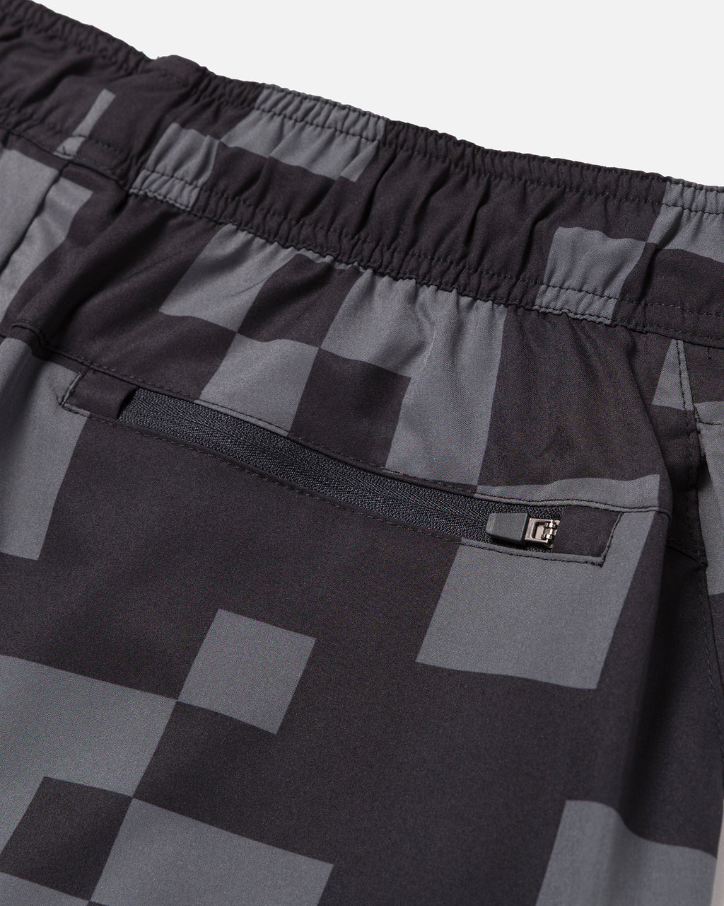 Black and gray checkered shorts with a zipper pocket