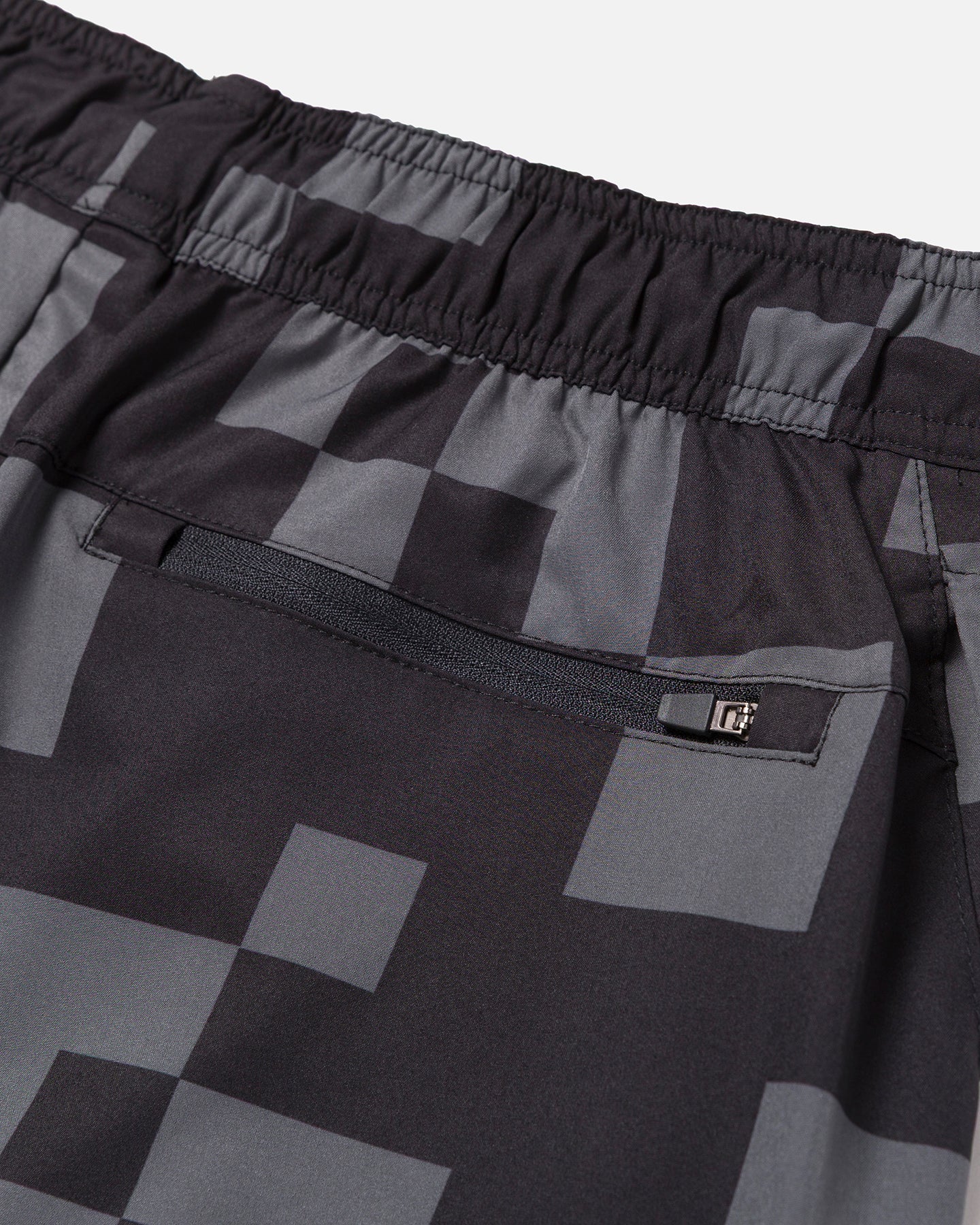 Black and gray checkered shorts with a zipper pocket