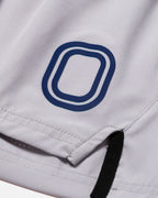 Close-up of a grey garment with a blue "O" logo