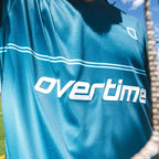 Blue sports jersey with "OVERTIME" logo