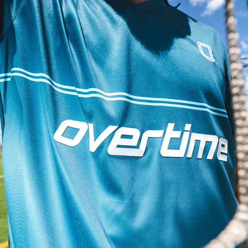 Blue sports jersey with "OVERTIME" logo
